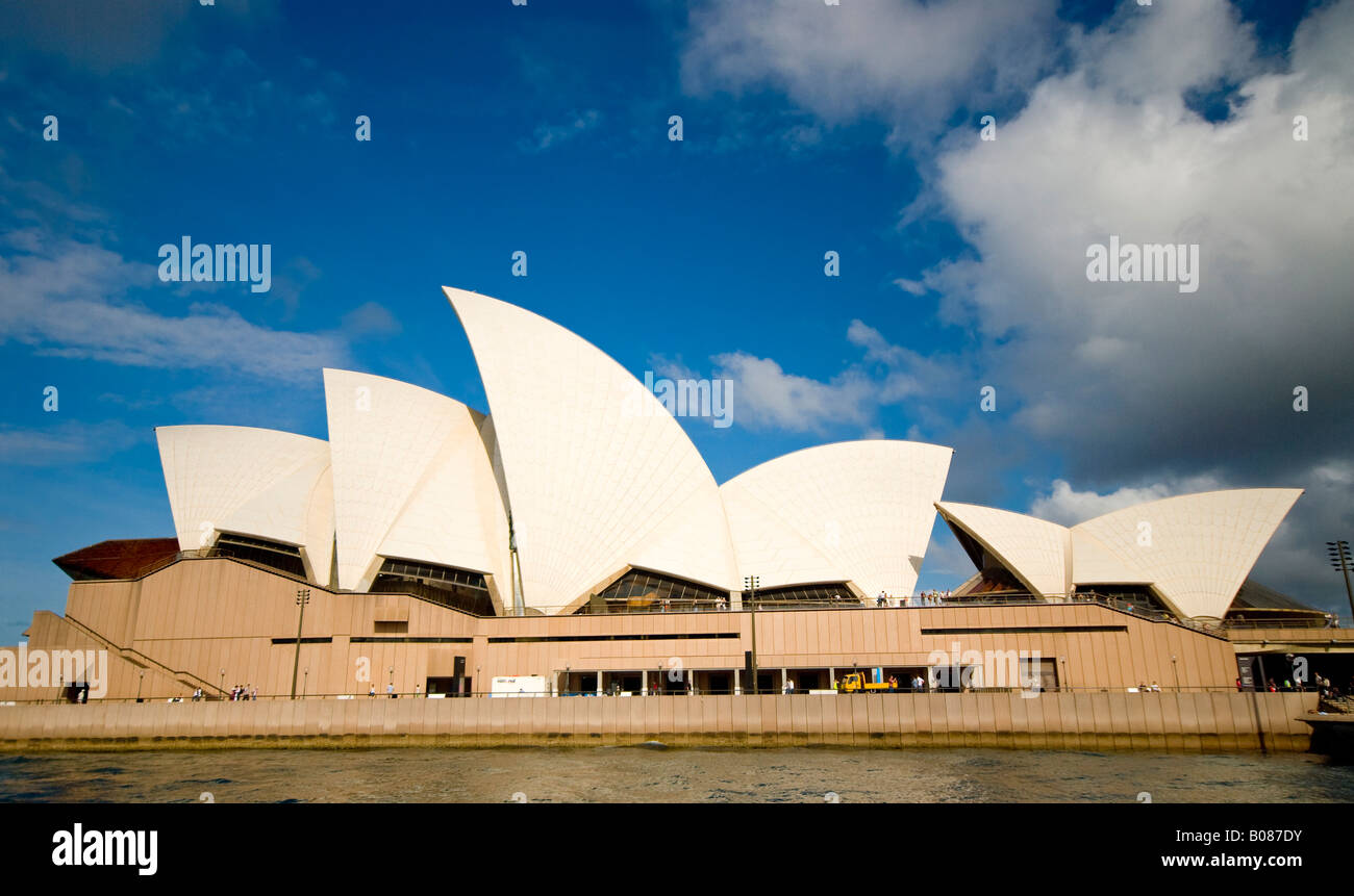 Sydney Opera House Sydney Australie // SYDNEY, Australie — L'Opéra de Sydney se trouve à Bennelong point sur le port de Sydney, vu du côté ouest de l'eau. Le lieu des arts de la scène, conçu par l'architecte danois Jørn Utzon, a ouvert ses portes en 1973 et est reconnu comme site du patrimoine mondial de l'UNESCO. L'Opéra abrite plusieurs salles de spectacle, dont la salle de concert, le théâtre Joan Sutherland et plusieurs petits théâtres et studios. Le design distinctif en forme de coquille du bâtiment en a fait l'un des monuments architecturaux les plus reconnaissables au monde. Port de Sydney, également connu sous le nom de Port Banque D'Images