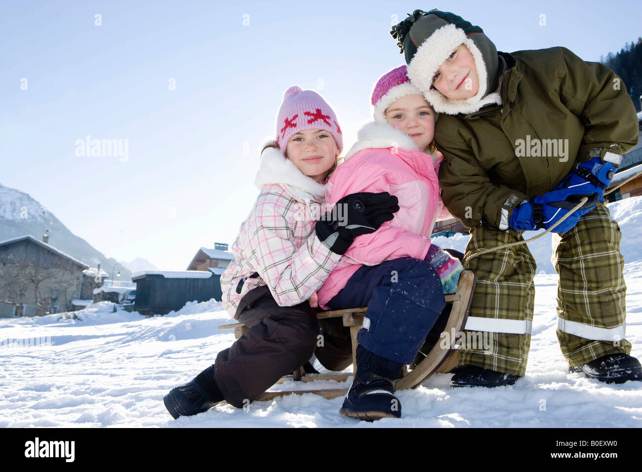 Des enfants jouent dans la neige avec Sled Banque D'Images