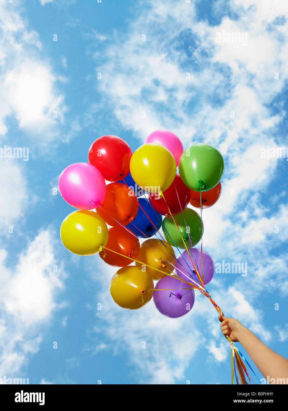 Hand holding colorful balloons Banque D'Images