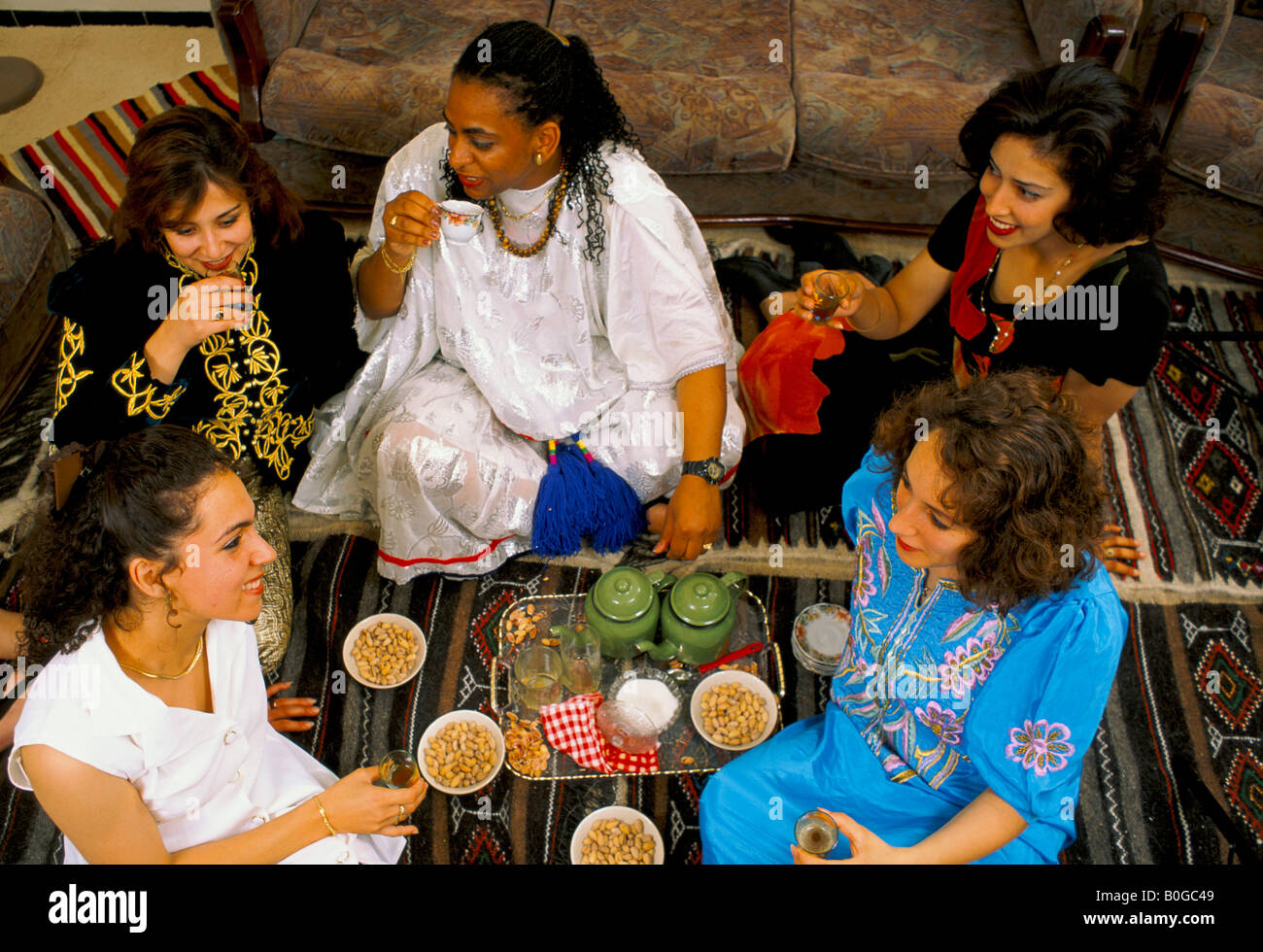 Un groupe de femmes assises sur le plancher tout en buvant du thé, de l'Algérie. Banque D'Images