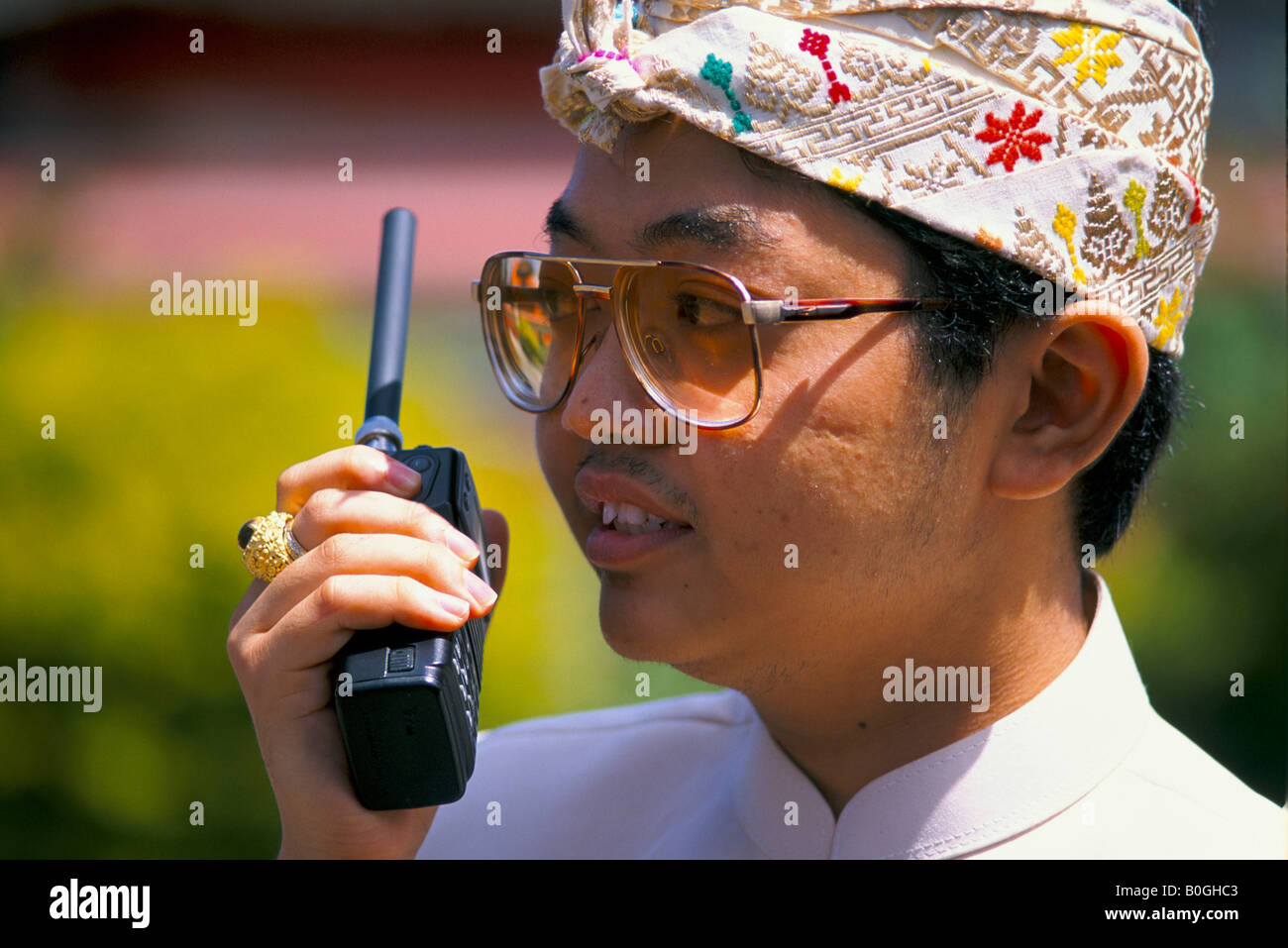 Un homme à l'aide d'un talkie-walkie, Bali, Indonésie. Banque D'Images