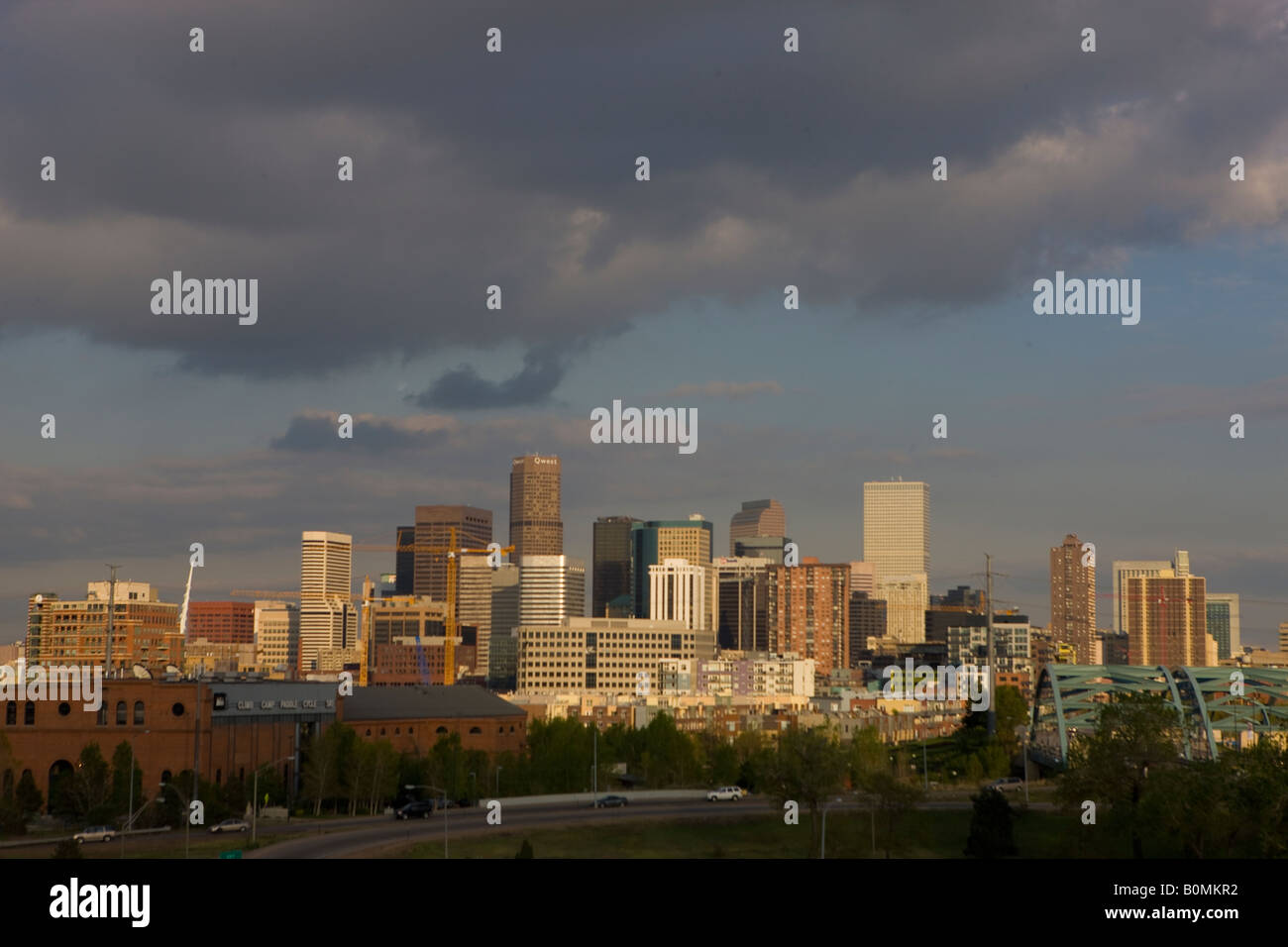 Vue sur la ville de l'ouest de Denver Colorado édifices voirie et gratte-ciel au coucher de soleil avec des nuages sombres Banque D'Images