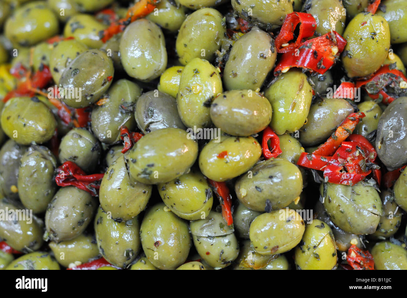 Olives vertes marinées aux poivrons rouges Banque D'Images