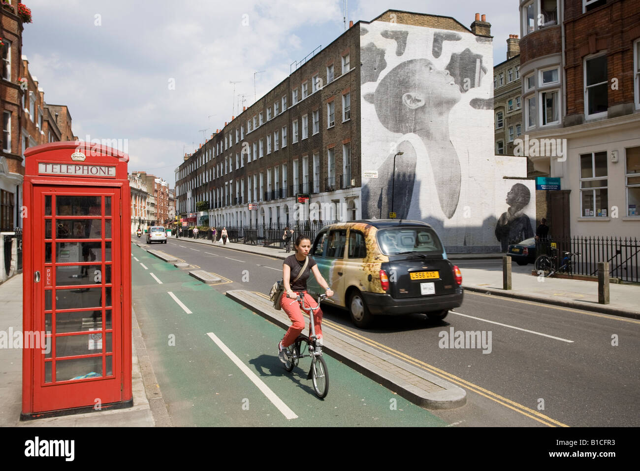 Cabine téléphonique, voie cyclable et peinture murale. Tavistock Place, Bloomsbury, Camden, London, England Banque D'Images