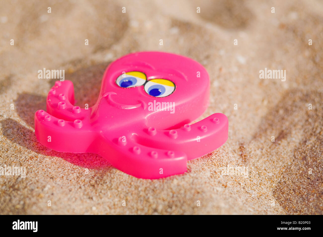 Octapus en plastique rose jouet de sable sur la plage Banque D'Images