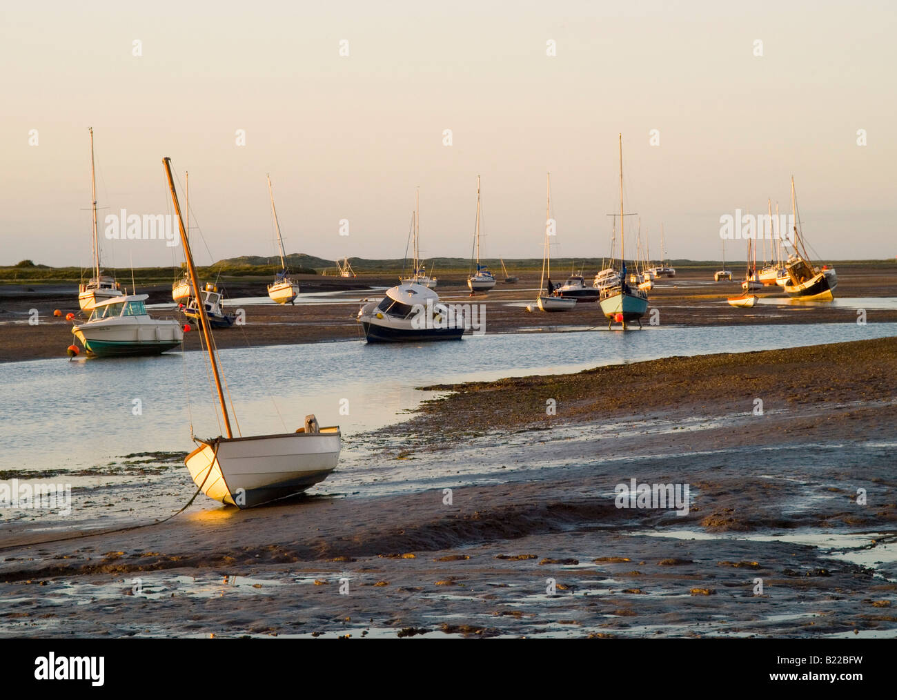 Bateaux à marée basse au coucher du soleil à Burnham Deepdale, North Norfolk Coast East Anglia UK Banque D'Images