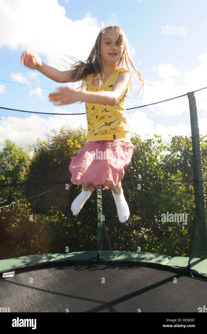 Une fillette de dix ans, de sauter sur un trampoline Banque D'Images