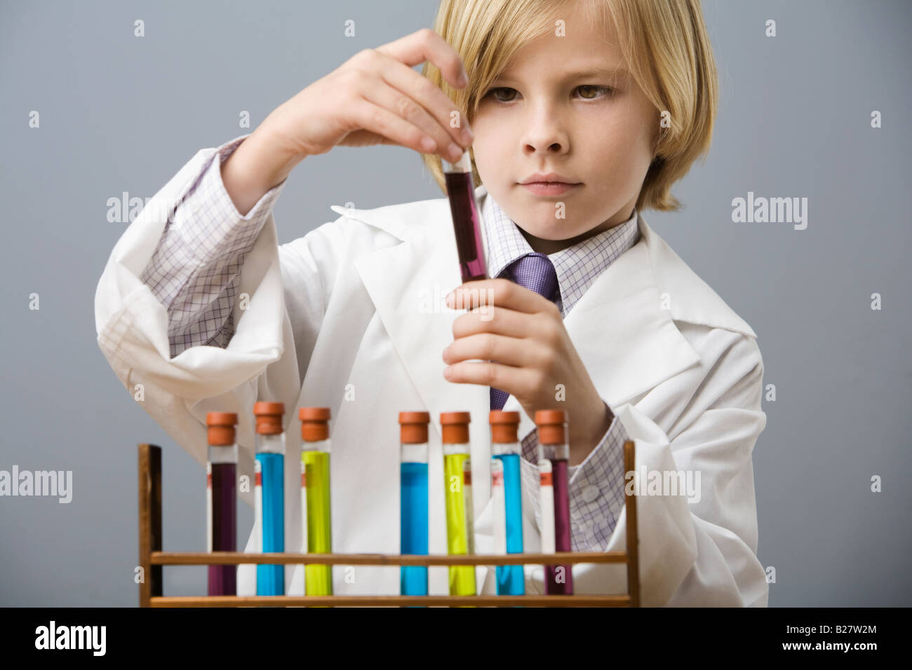 Boy looking at flacon de liquide Banque D'Images