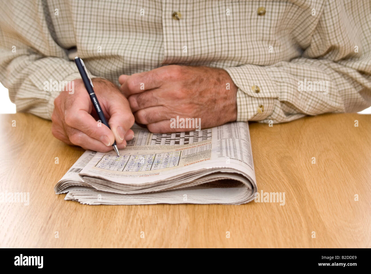 Portrait horizontal d'un monsieur âgé faisant le puzzle Sudoku dans son quotidien Banque D'Images