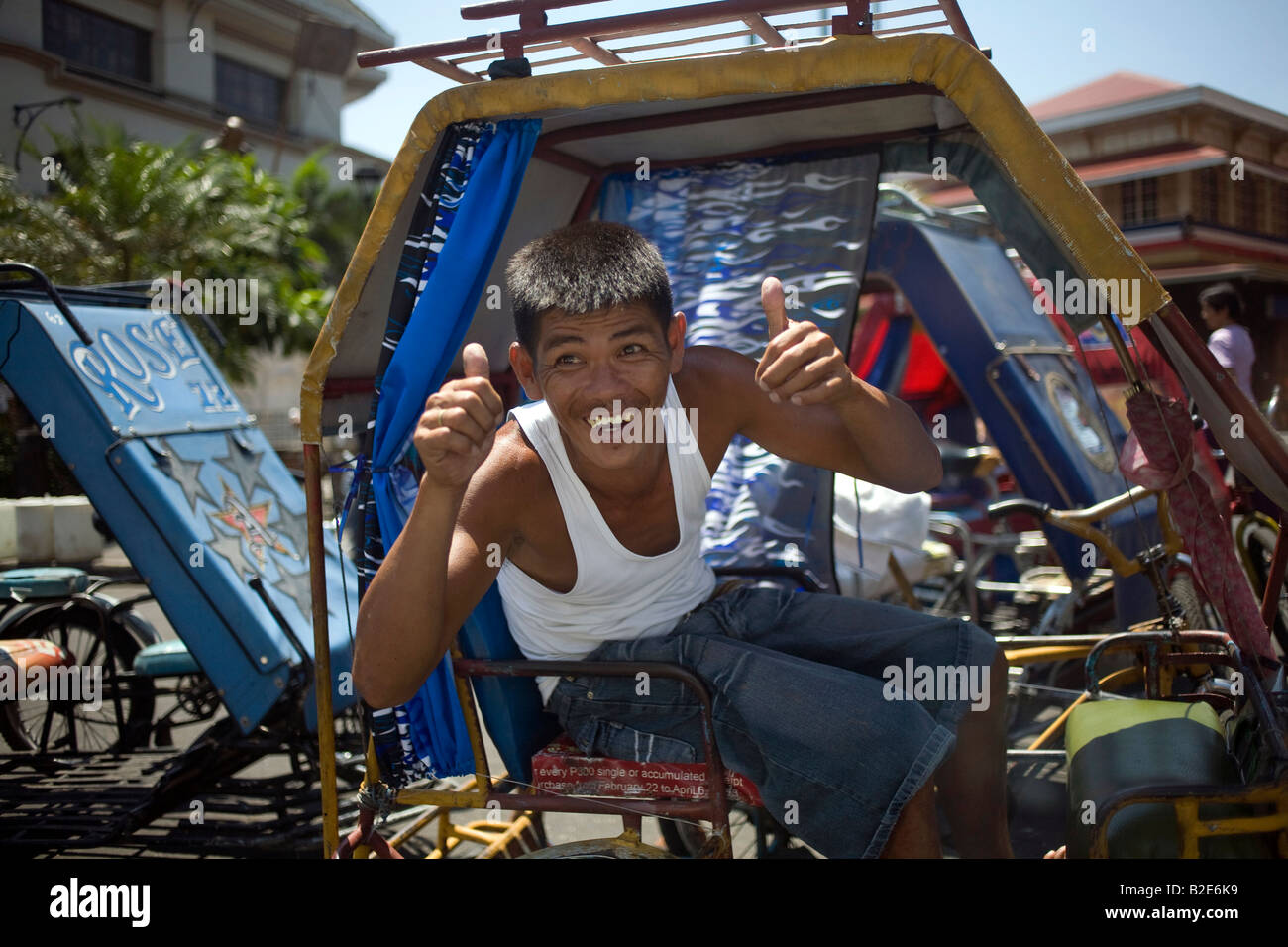 Un tricycle pour enfant pilote dans le district de Divisoria Metro Manila, Philippines. Banque D'Images