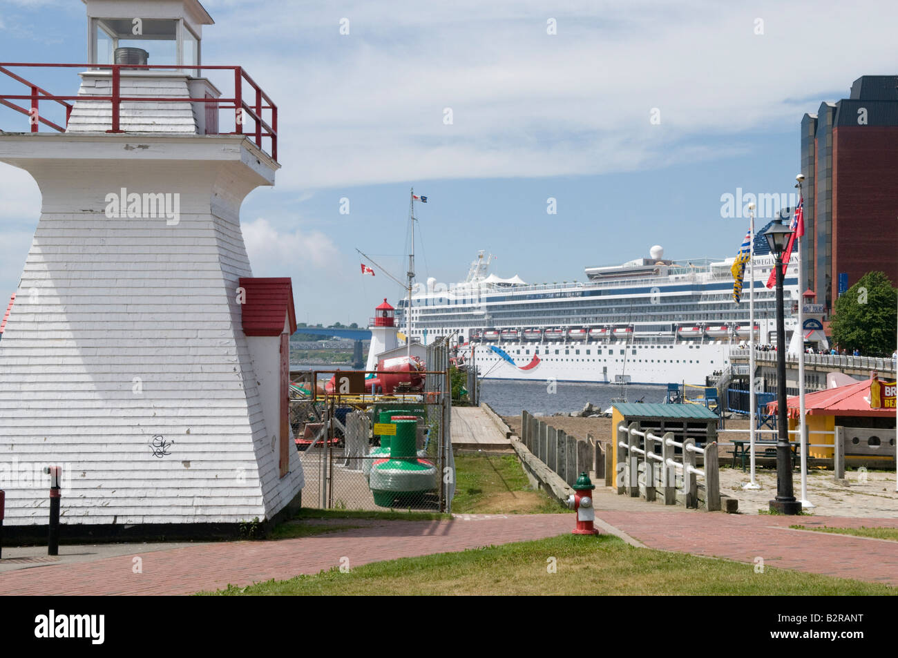 Saint John Harbour avec phare de la garde côtière norvégienne et l'aube d'un navire de croisière dans le port sur un jour d'été ensoleillé Banque D'Images