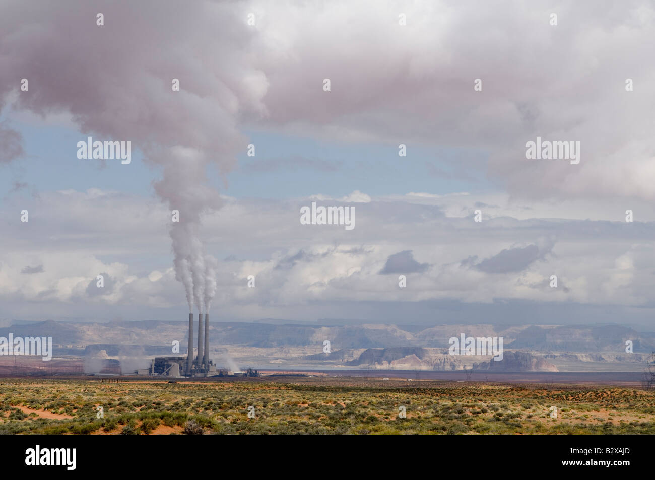 La combustion du charbon électrique émet de la fumée blanche qui atteint jusqu'à rejoindre les nuages blancs moelleux Banque D'Images