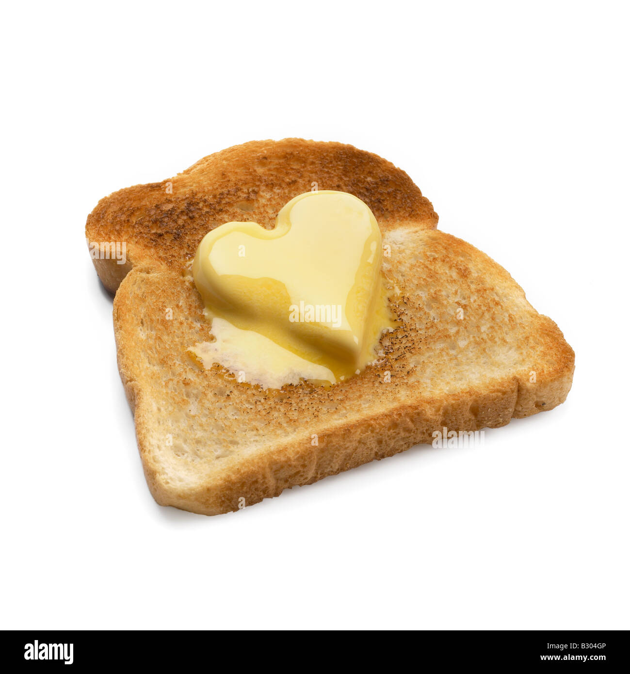 Tranche de pain grillée avec noix de beurre en forme de cœur Banque D'Images