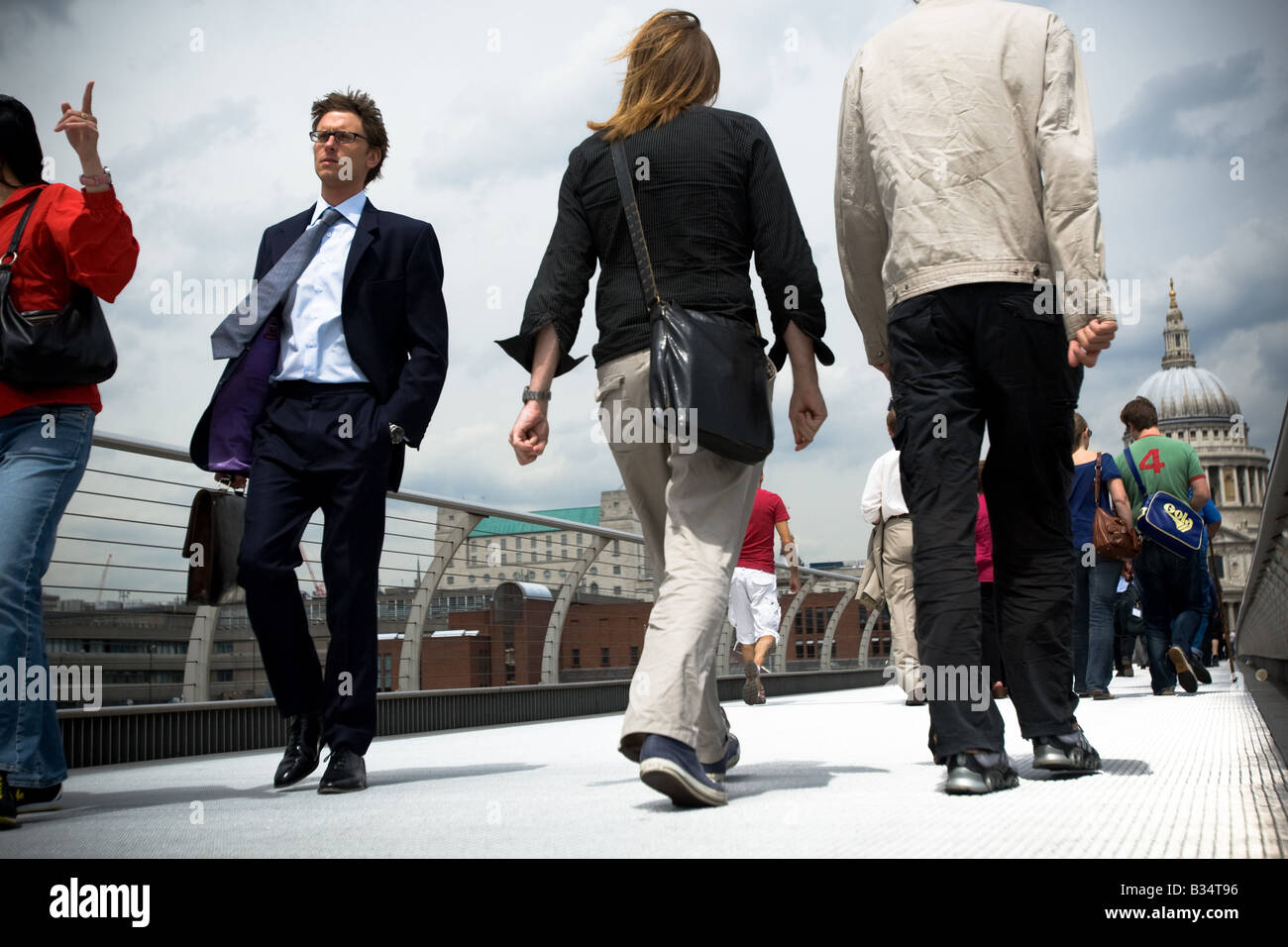 Un jeune homme traverse le pont du Millenium à Londres, Royaume-Uni Banque D'Images