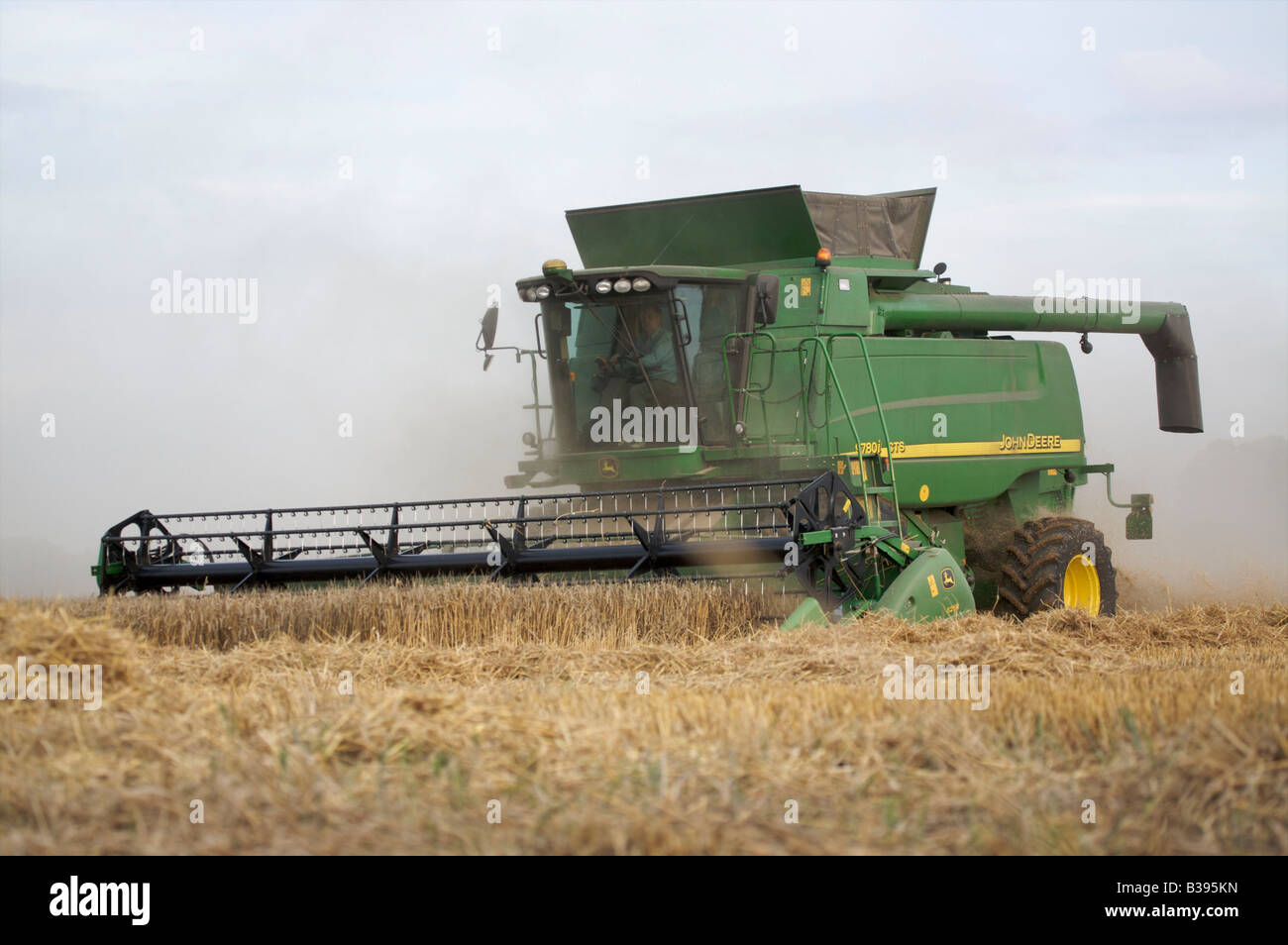 Moissonneuse-batteuse John Deere la récolte du blé d'hiver dans des conditions poussiéreuses Banque D'Images