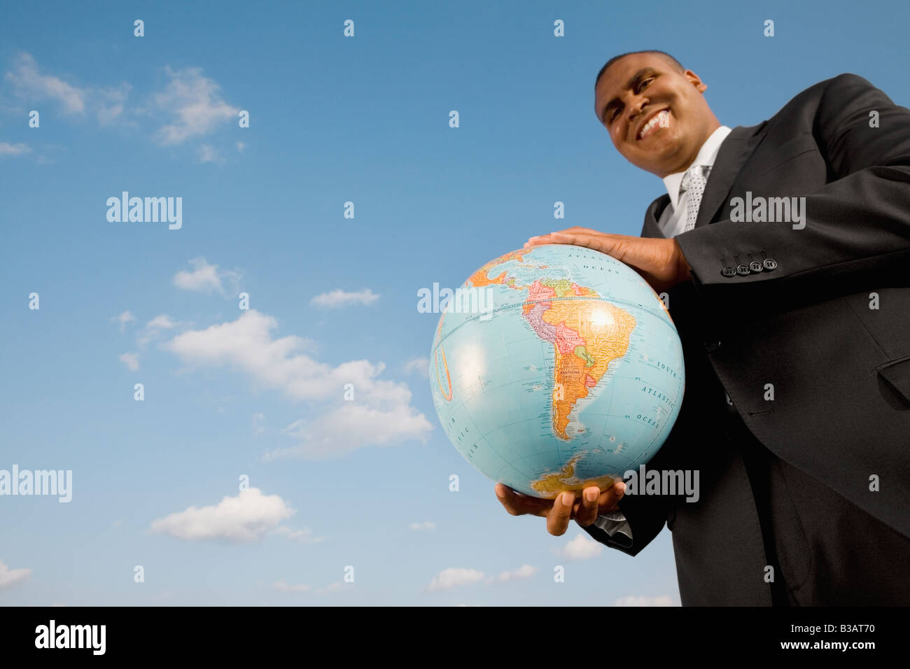 African businessman holding globe Banque D'Images