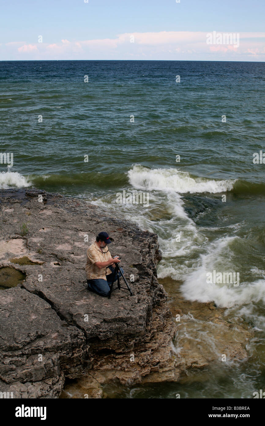 Photographe sur la côte ouest rocheuse du lac Michigan Banque D'Images