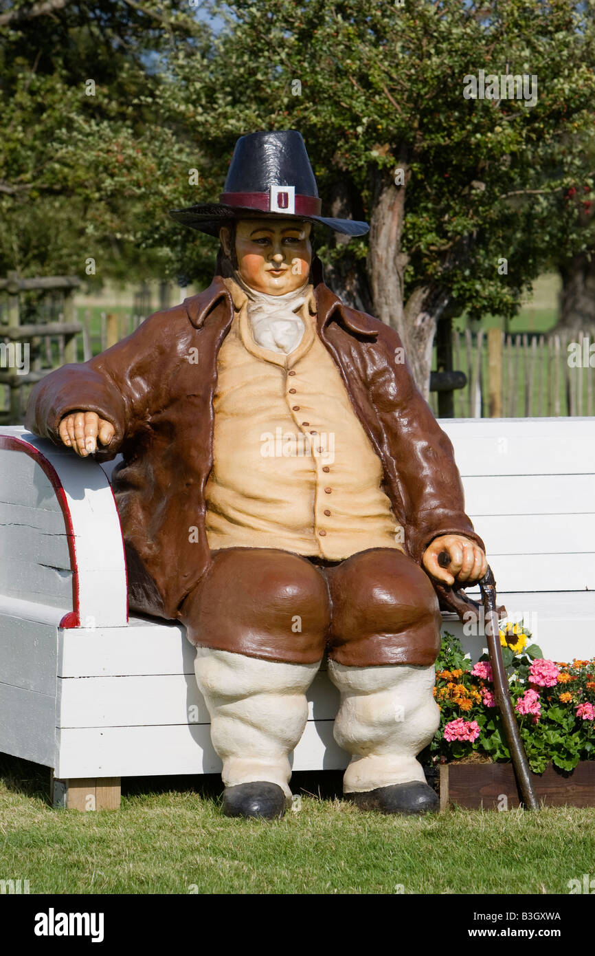 Sculpture en bois d'un homme obèse habillé en vêtements du 17ème siècle dans le parc de Burghley House dans le Lincolnshire. Banque D'Images