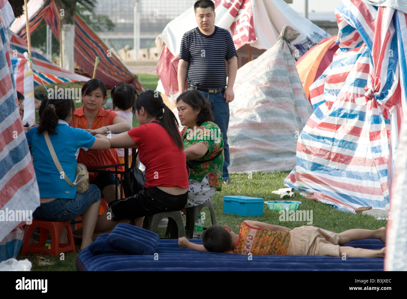 Les survivants du séisme au Sichuan le 12 mai 2008 tuer le temps dans un parc de tentes de fortune leur logement dans le Sichuan, Chine Banque D'Images