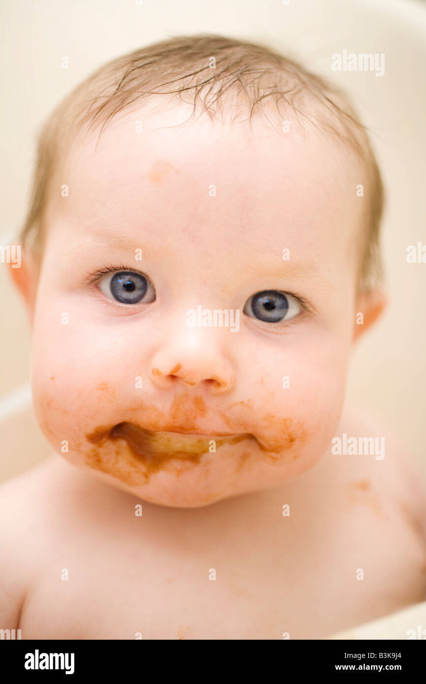 Un Bebe Rigolo A Large Vue A Un Smirk Sur Son Visage Et De La Nourriture De Bebe Malteuse Sur Tout Son Visage Photo Stock Alamy