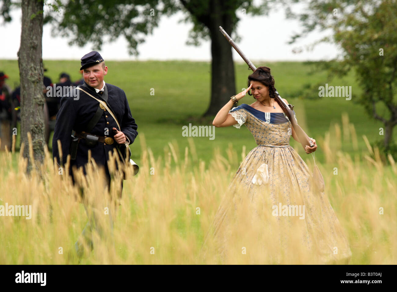 Une jeune femme flirtingly saluant un soldat de l'union à une guerre civile Reenactment Campement Banque D'Images
