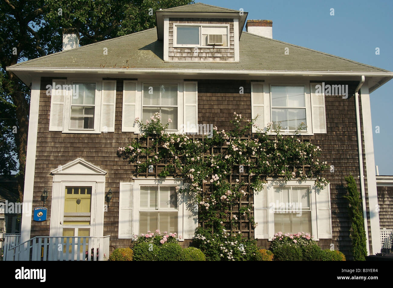 Amérique du Nord, USA, Massachusetts, Martha's Vineyard Edgartown,.l'avant d'une maison de bardeaux avec fleurs de grimper un treillis Banque D'Images