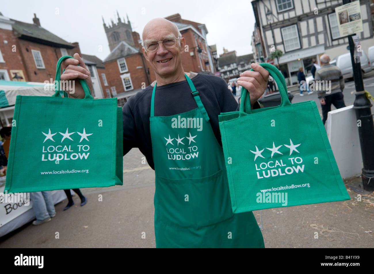 Man selling Local au Ludlow green shopping sacs chez Food Festival Ludlow Shropshire England UK Banque D'Images