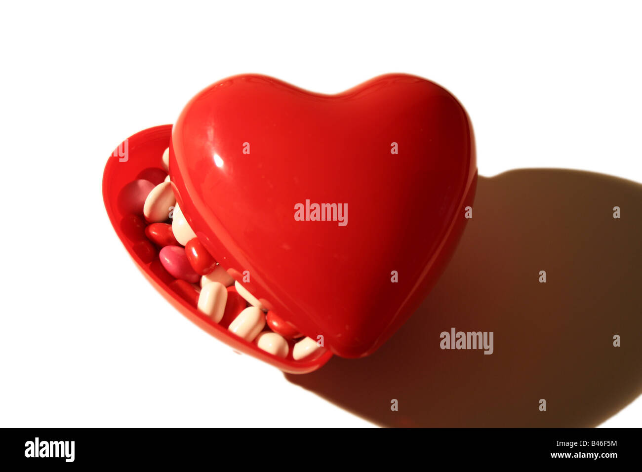 A cute valentine candy heart concept isolated on white Banque D'Images