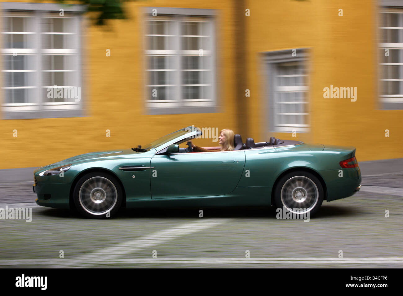 Aston Martin DB9 Volante, l'année de modèle 2005-, vert, la conduite, la vue de côté, la ville, open top, juridiques, conducteur à droite Banque D'Images
