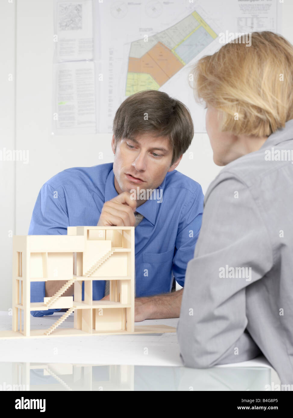 Deux personnes de discuter d'un modèle d'architecture Banque D'Images