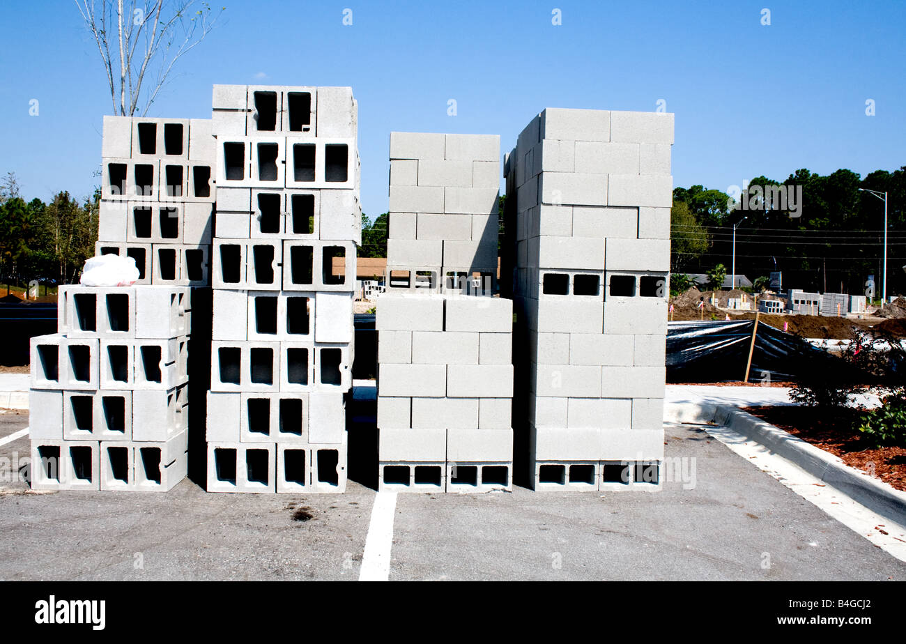 Des piles de briques de construction en béton blanc sur un site de construction dans un parc de stationnement Banque D'Images