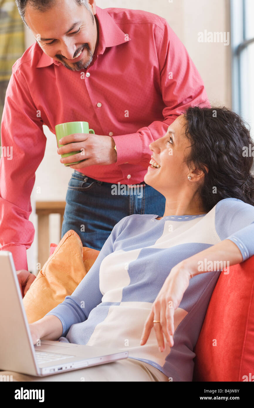 Hispanic couple smiling at each other Banque D'Images