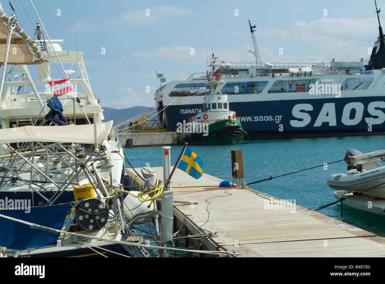 Un remorqueur à l'arrière d'un grand ferry grec et d'autres bateaux au port de Lavrion Grèce continentale Banque D'Images