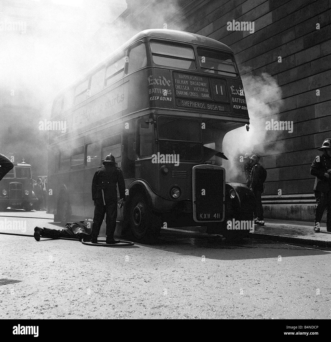 Bus à impériale rouge en feu mai 1959 pompiers tentent de lutter contre l'incendie Banque D'Images