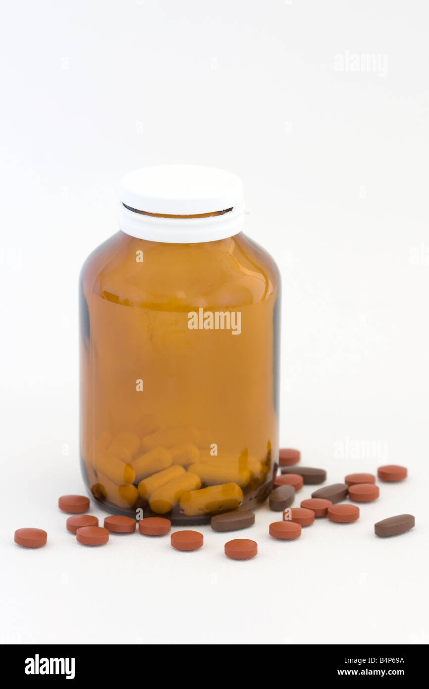 Comprimés dans une bouteille sur un fond blanc Banque D'Images