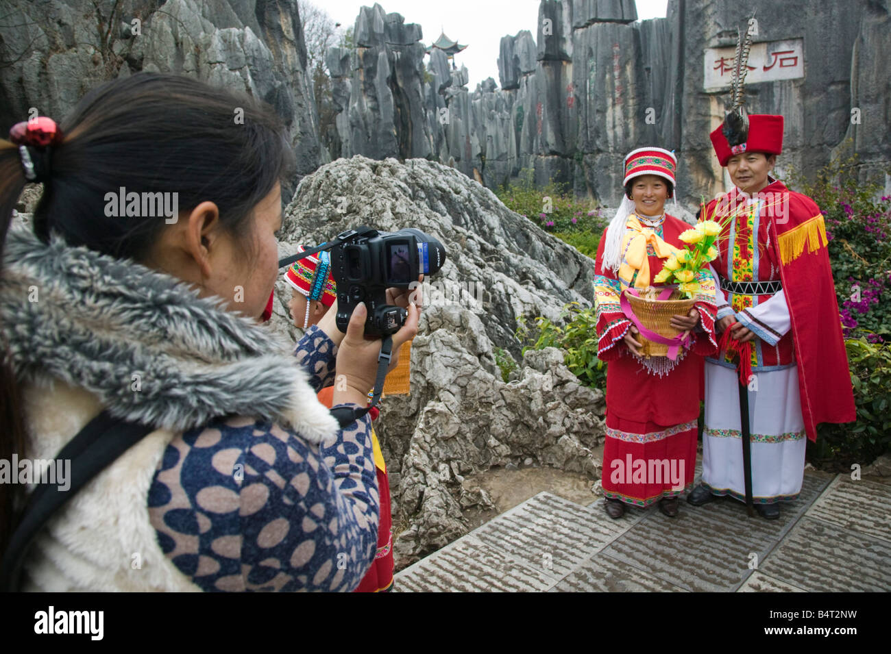 Chine, Province du Yunnan, Kunming, Shilin, la forêt de pierre, les visiteurs chinois habillés en costumes locaux Personnes Sani Banque D'Images