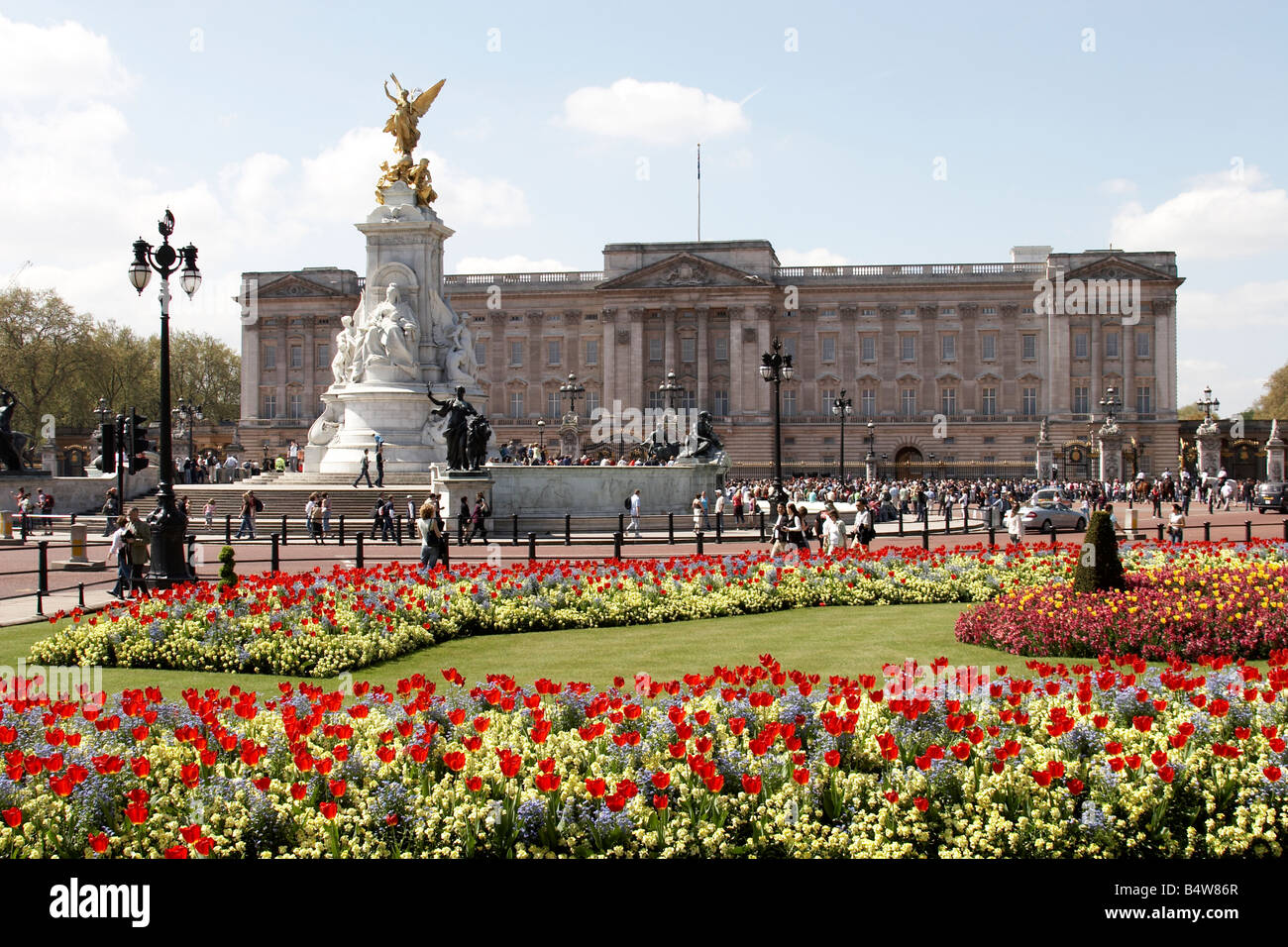 Des massifs de fleurs et les touristes en face de l'Édifice commémoratif Victoria Buckingham Palace SW1 London England Banque D'Images