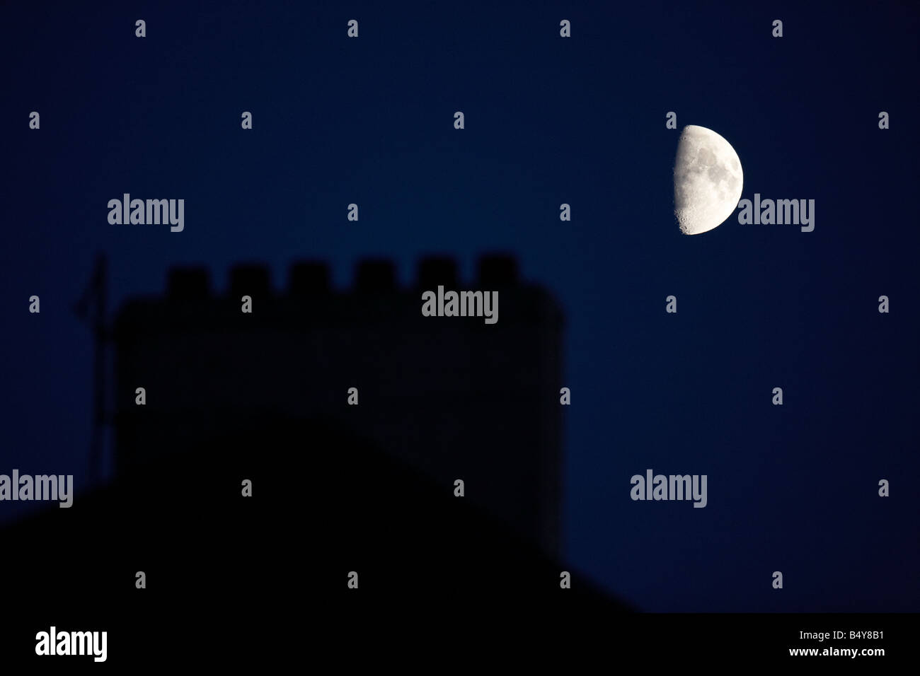 Vue partielle de la demi-lune qui s'élève au-dessus de la cheminée d'un pot de cheminée victorienne nuit Banque D'Images