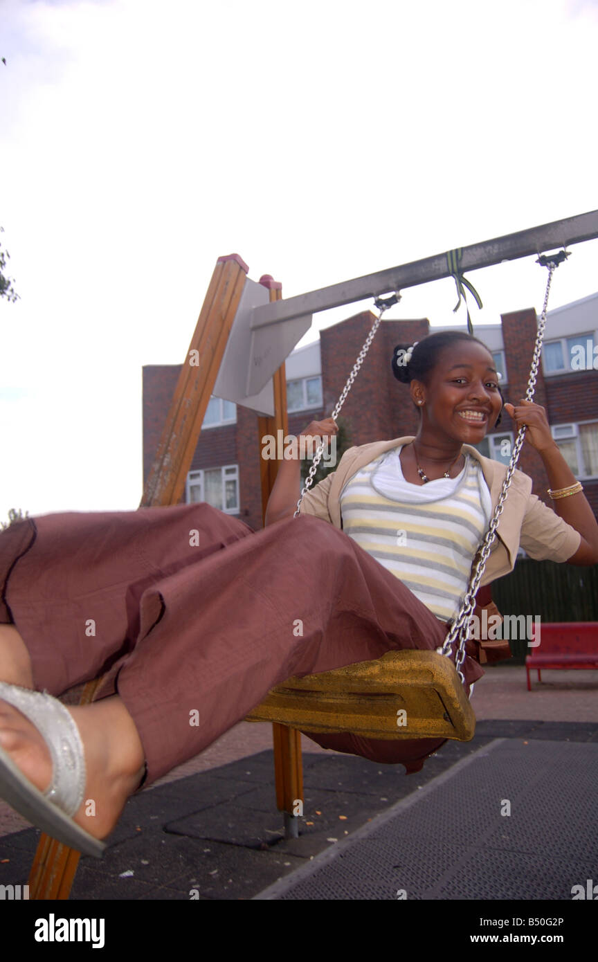 A smiling afro-caraïbes girl on swing Banque D'Images