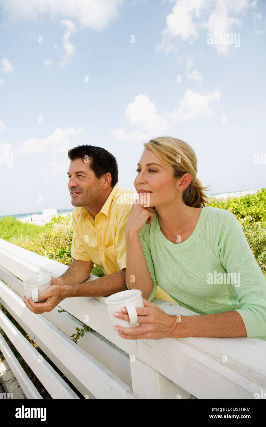 Couple Leaning on Wooden Fence Banque D'Images