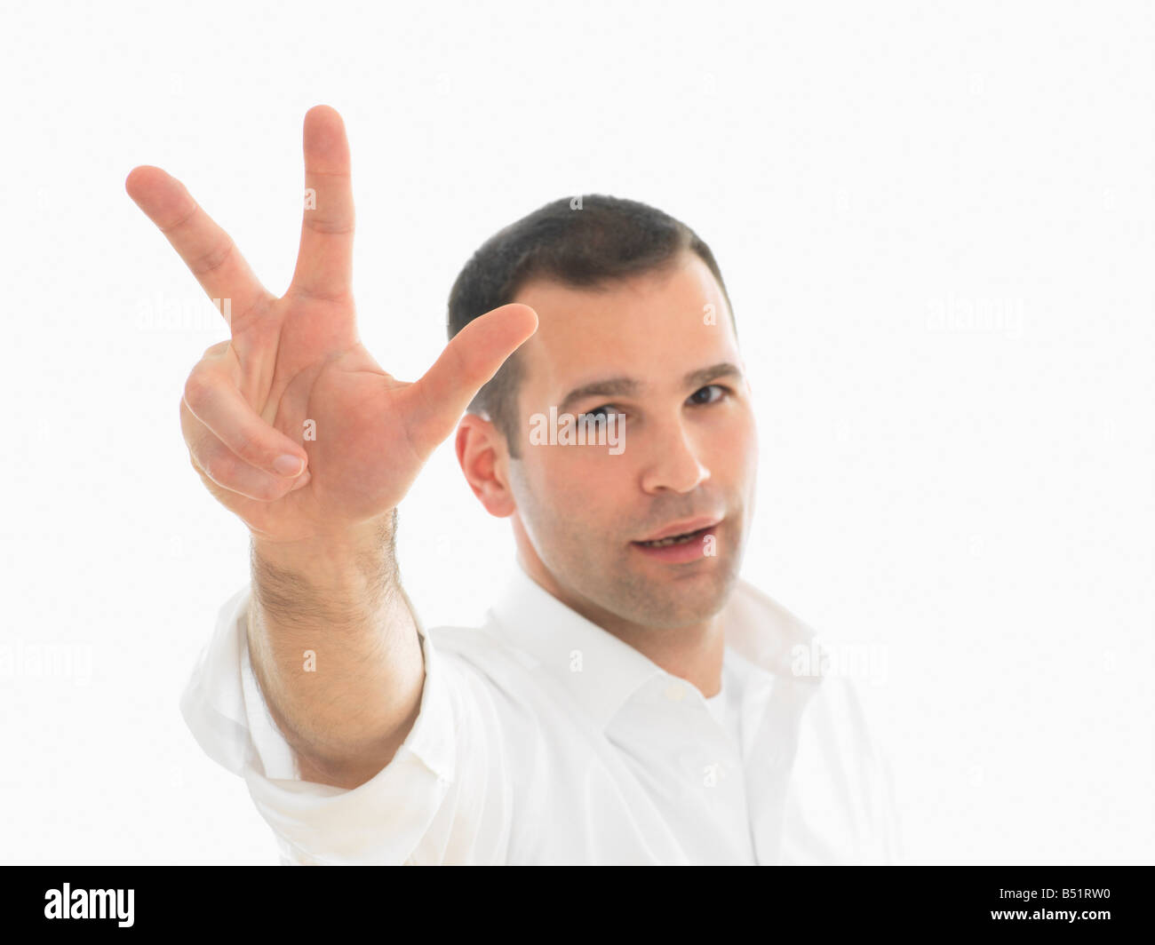 Portrait of Man Holding Up trois doigts Banque D'Images