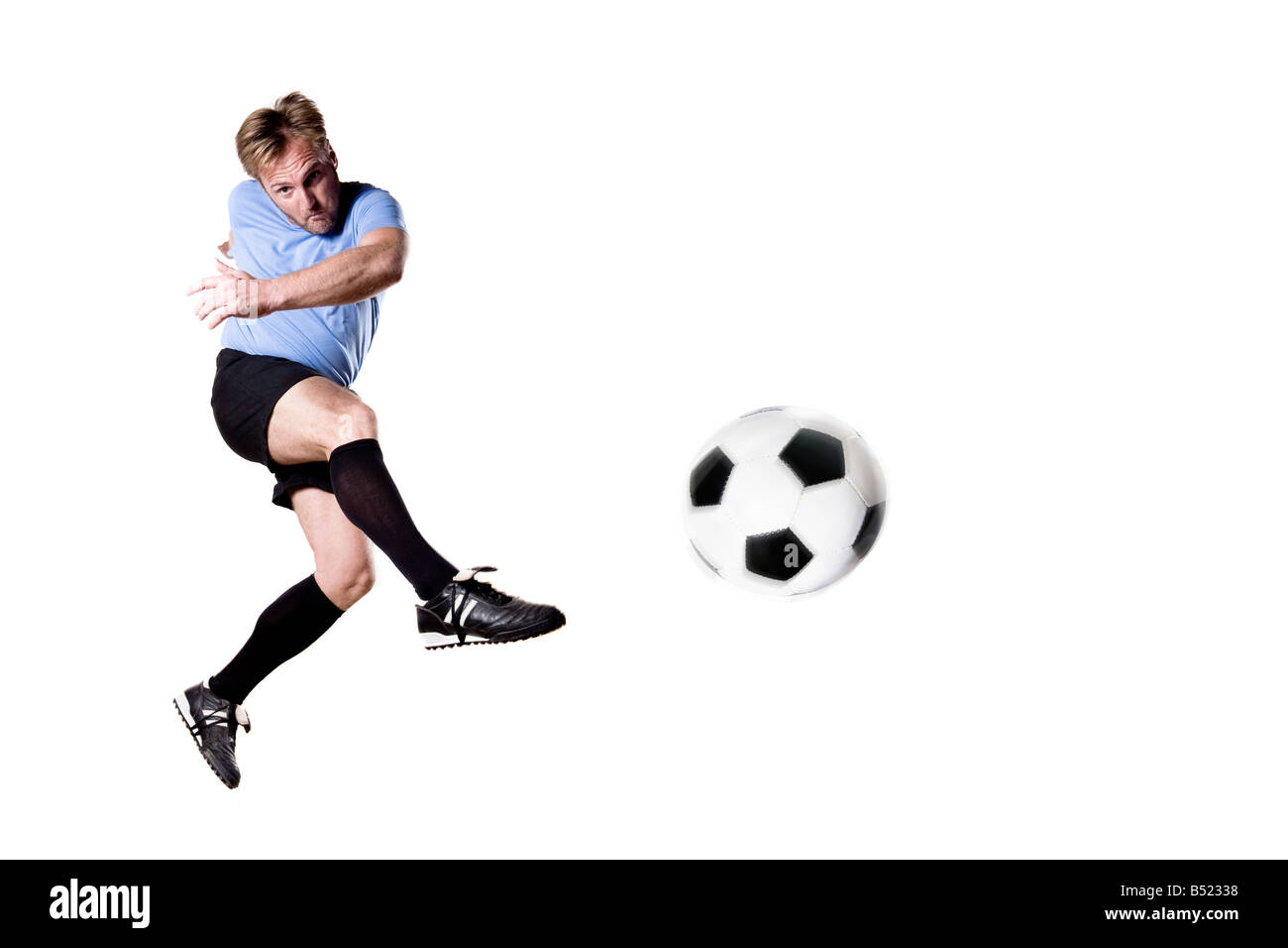 Joueur de football en pleine action photo studio isloted Banque D'Images