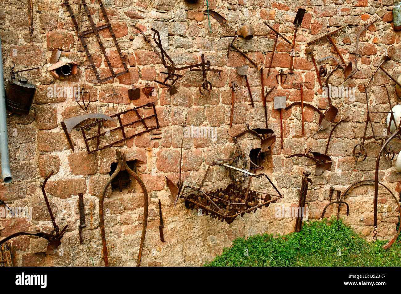 Outils rural antique dans une antique mur d'une maison. Prades (Barcelona) Catalogne Espagne Banque D'Images
