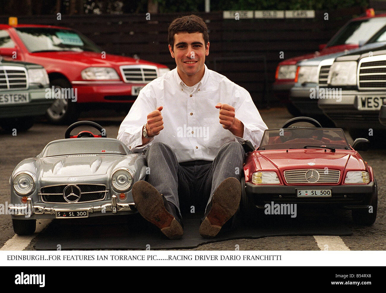 Dario Franchitti se trouve entre deux modèles miniatures de Mercedes Benz Banque D'Images