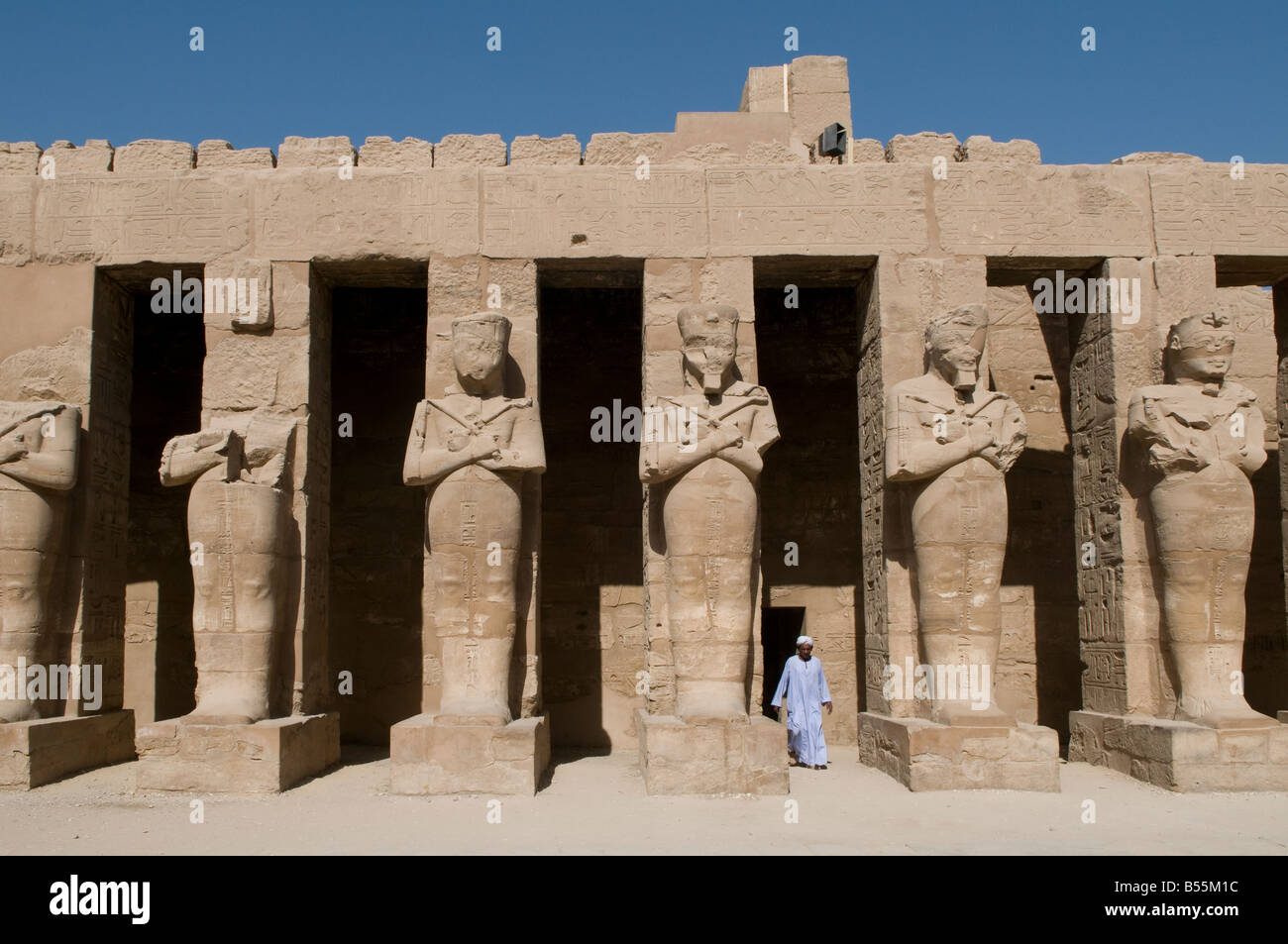 Un égyptien se dresse des statues de Ramsès II comme Osiris à la cour ouverte au Temple de Ramsès III, le Temple de Karnak à Louxor situé près de l'Egyp Banque D'Images
