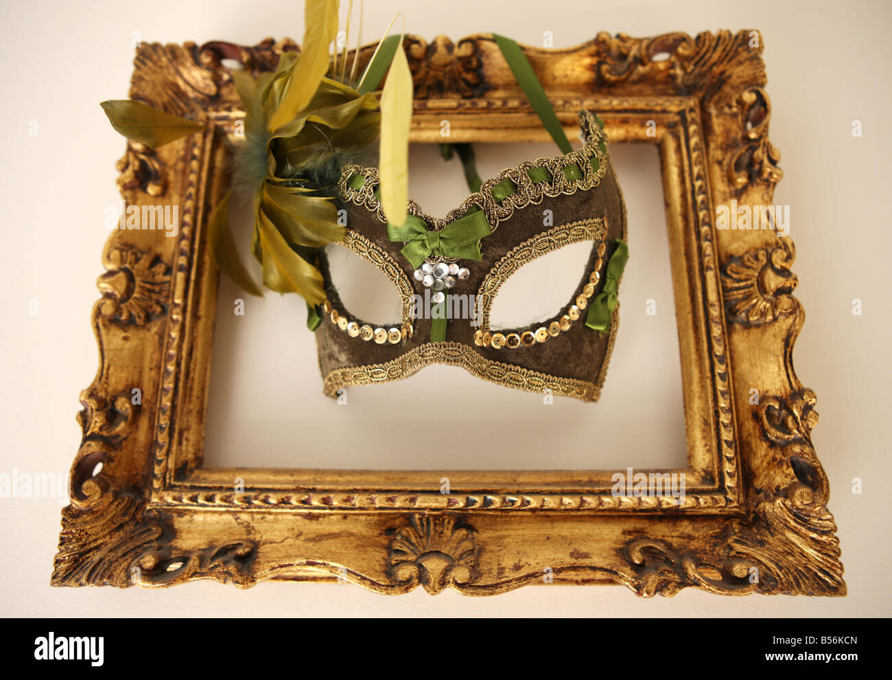 Masque vénitien décoratif dans un cadre d'or Photo Stock - Alamy