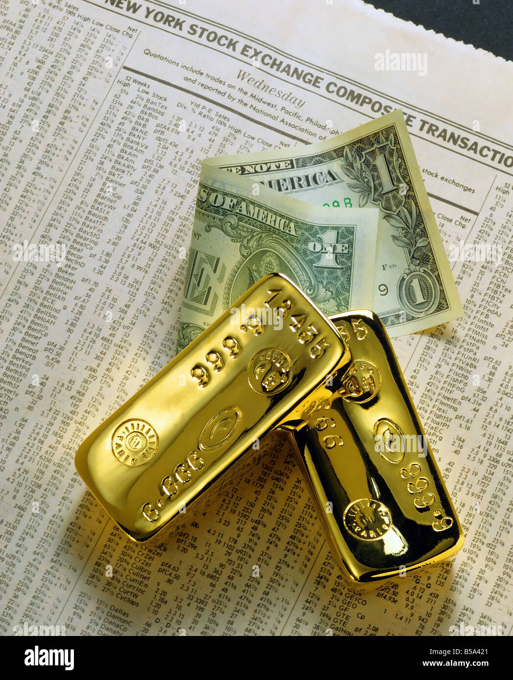 Deux barres d'or et un dollar sur papier financier Banque D'Images