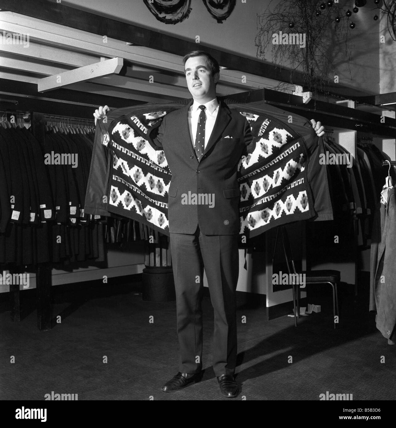 Modèle masculin portant un manteau de magasin. 1966 Banque D'Images