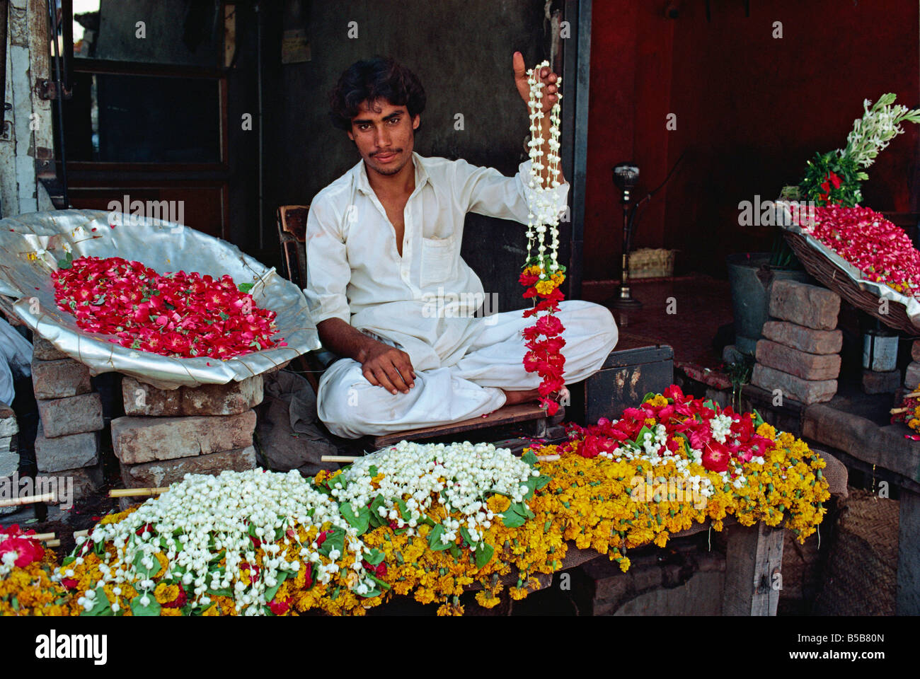 Portrait d'un homme vend des guirlandes de fleurs dans le marché aux fleurs à Lahore Pendjab Pakistan Asie UNE Evrard Banque D'Images