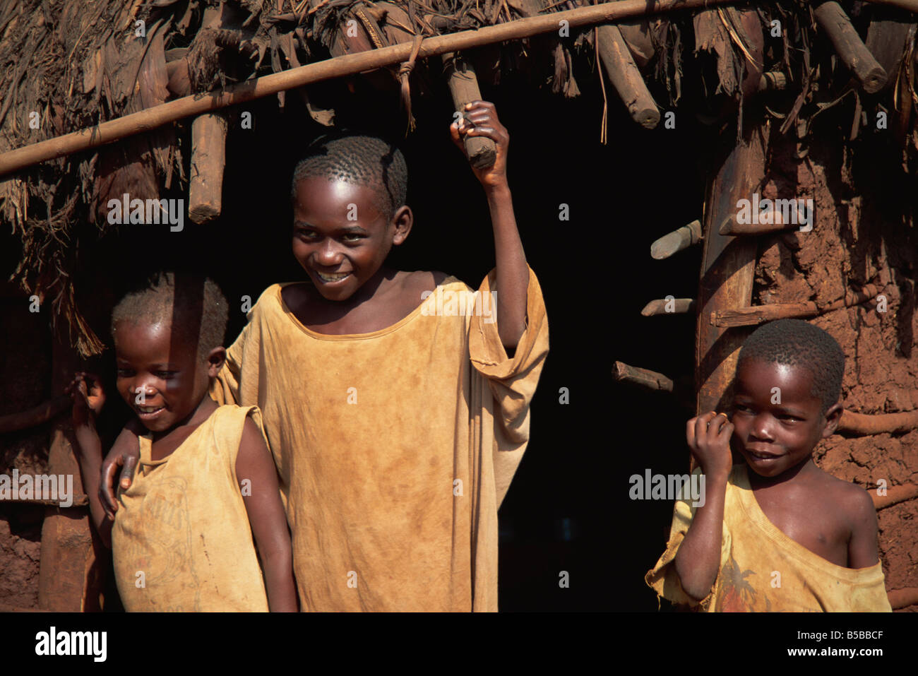 Enfants heureux à l'extérieur de l'Afrique de l'Est cabane de torchis Ouganda Afrique Banque D'Images